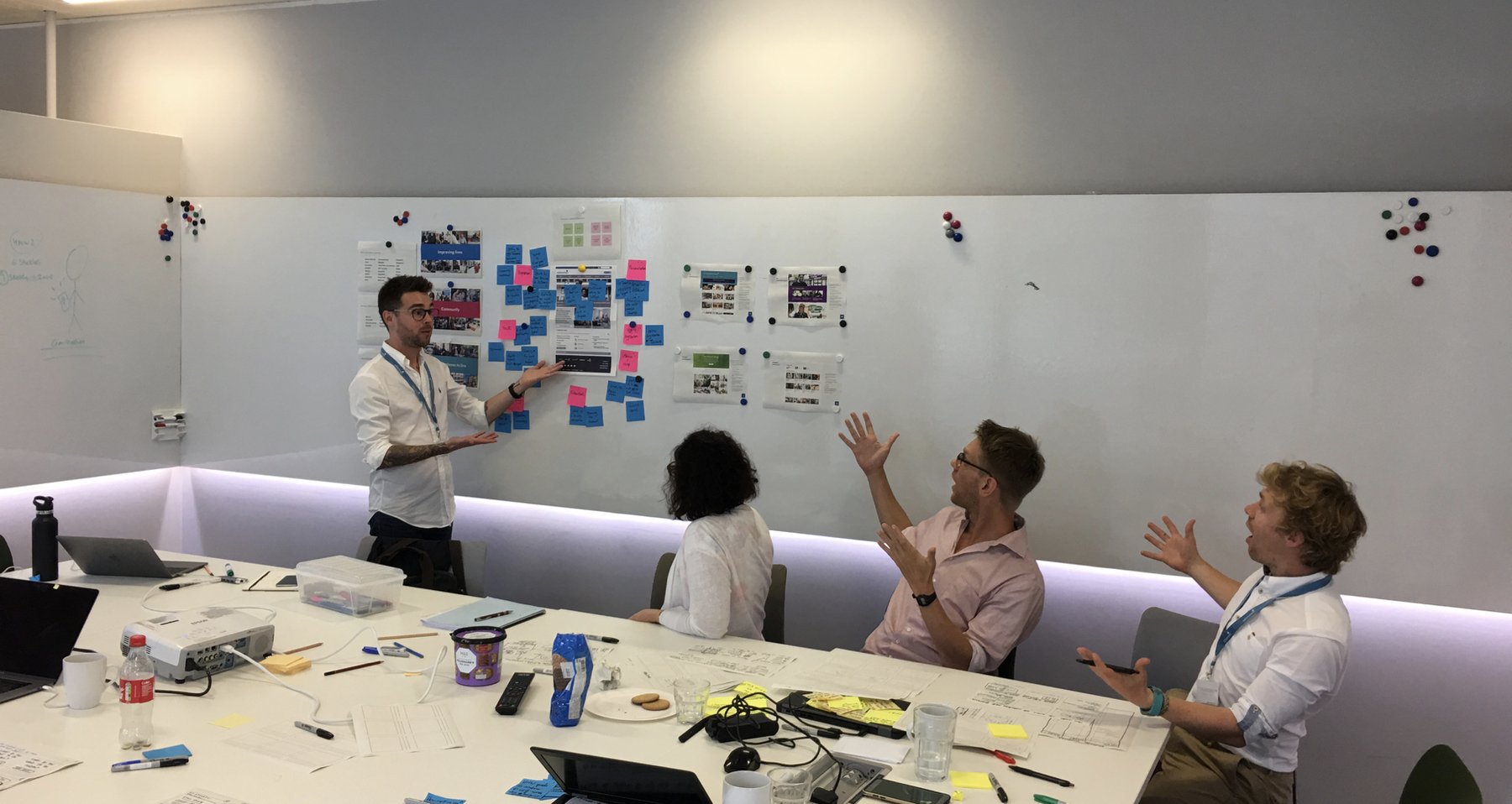 Leading a workshop at A2Dominion, the team reacting to work pinned on the wall