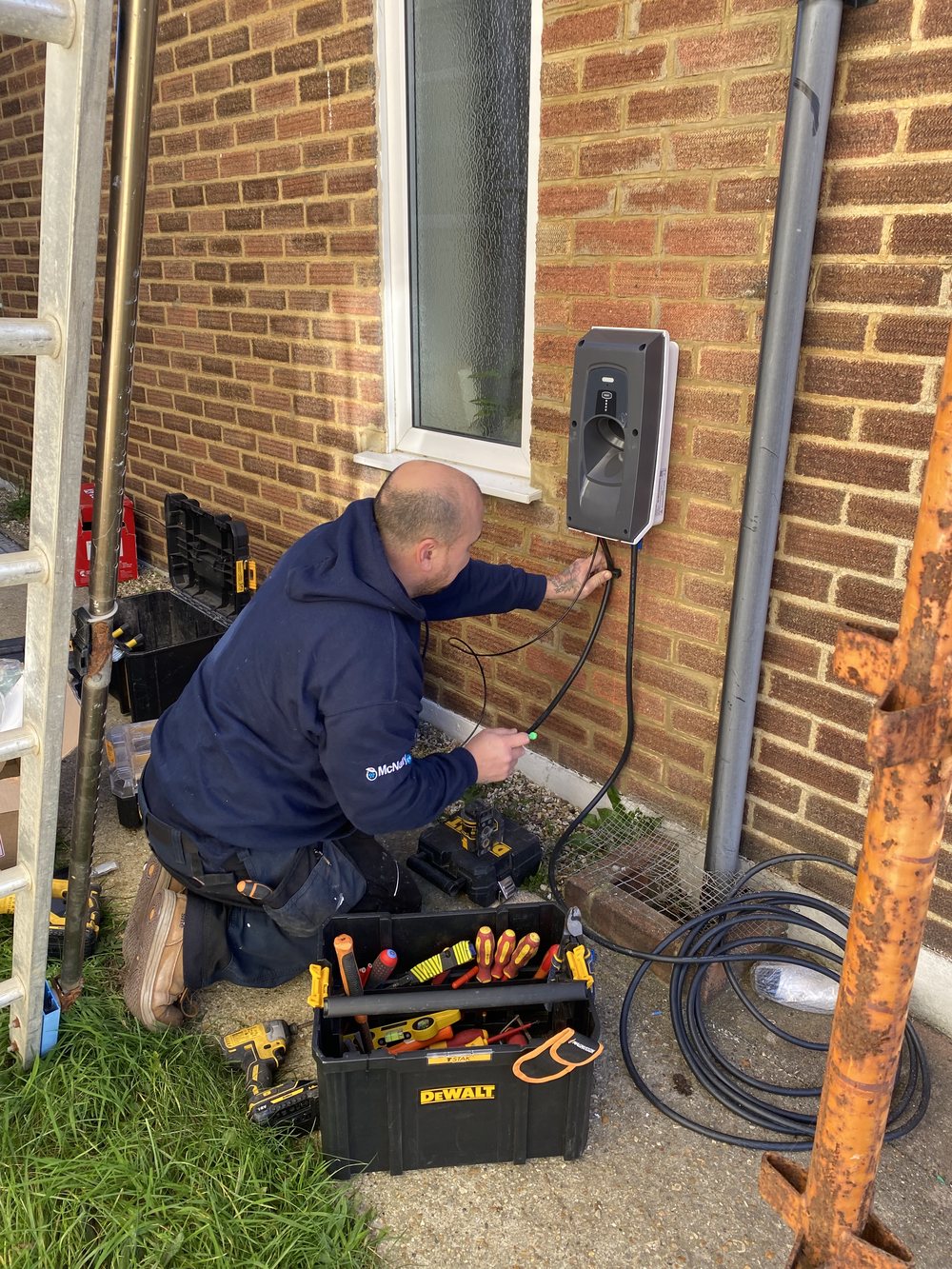 An installer fitting an Indra charger