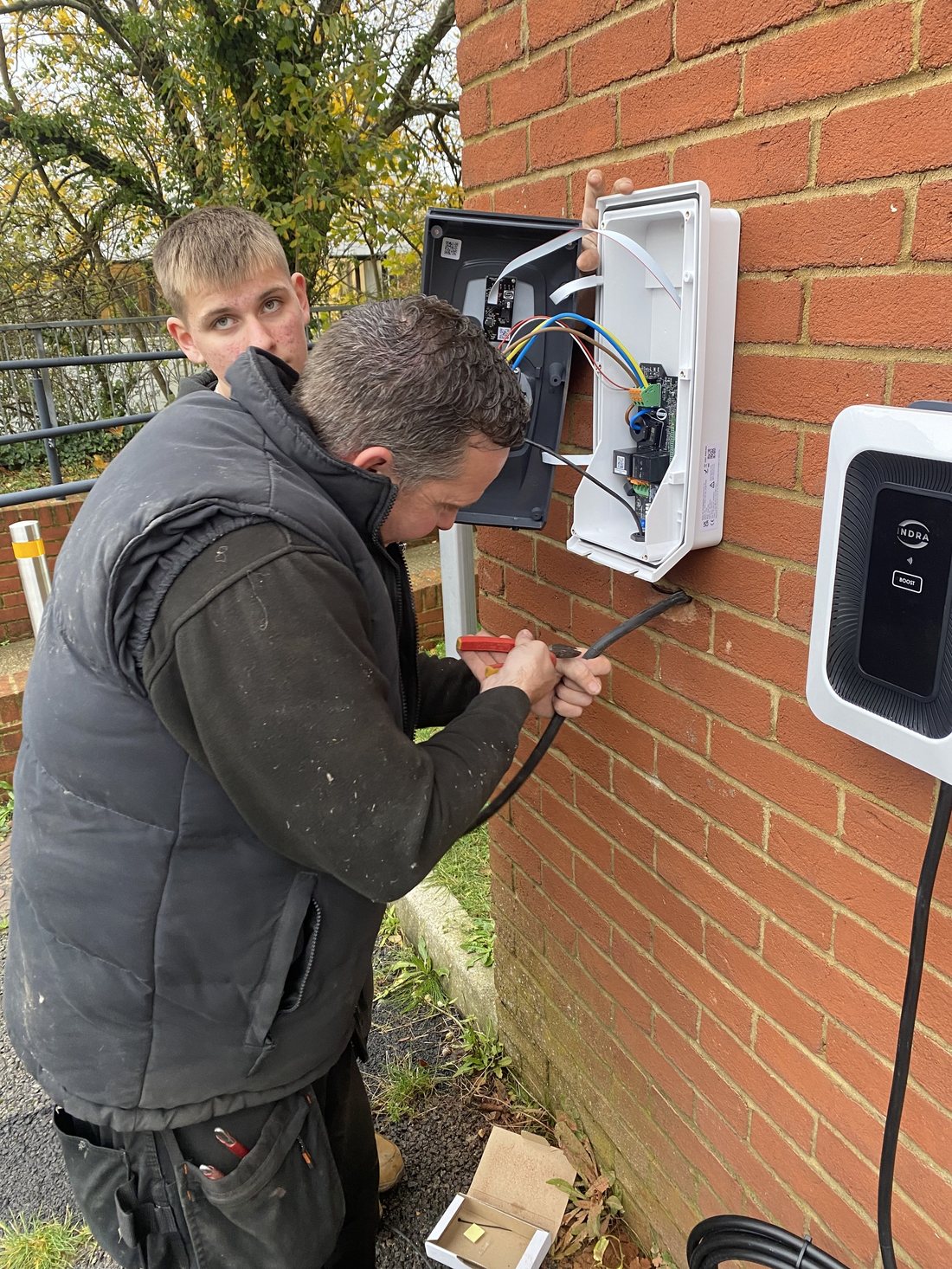 Installers fitting a charger on site